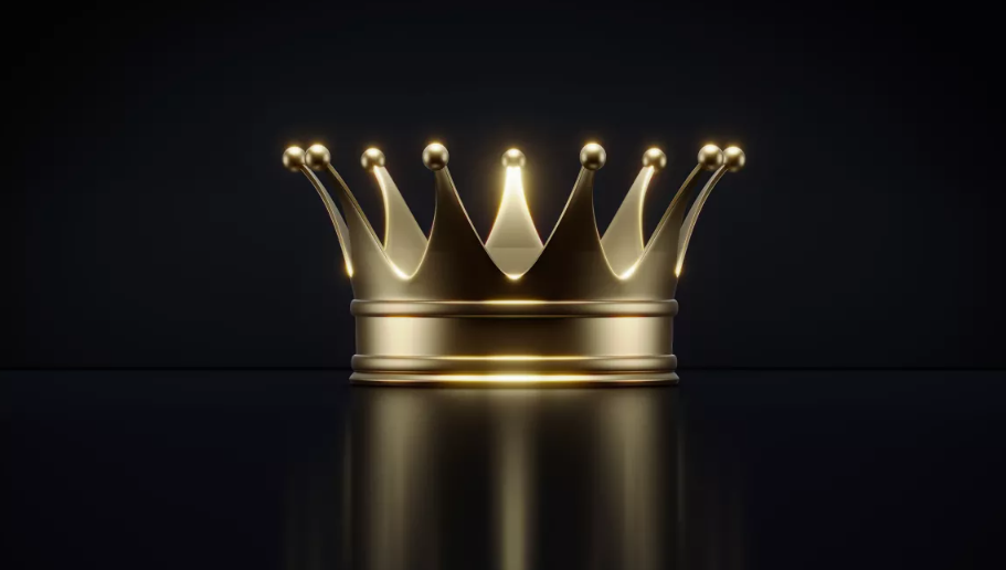 Shiny gold crown with rounded tips resting on a reflective black surface, dramatically lit against a dark background to emphasize its regal and luxurious appearance.