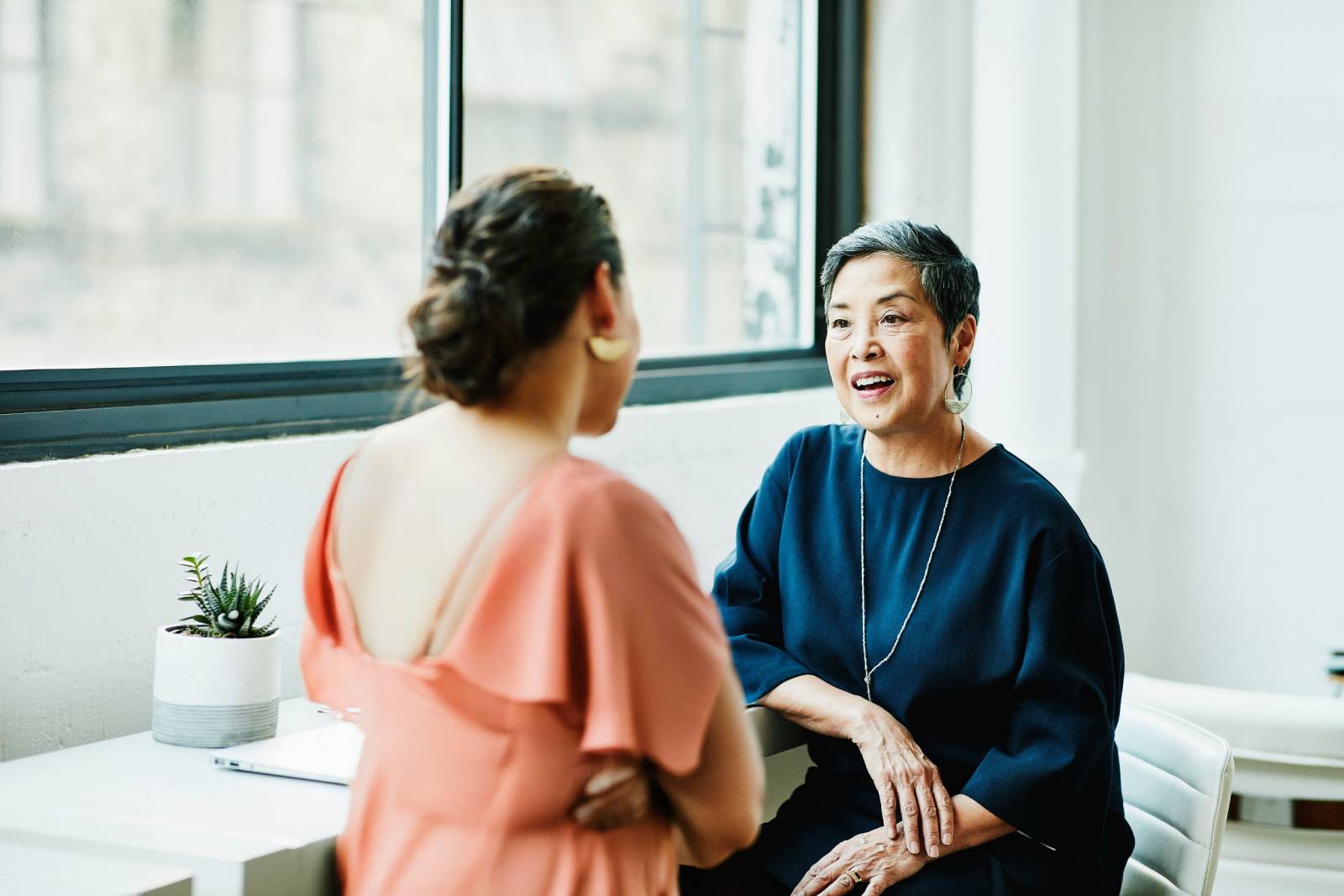 Two women meet in a cafe to talk