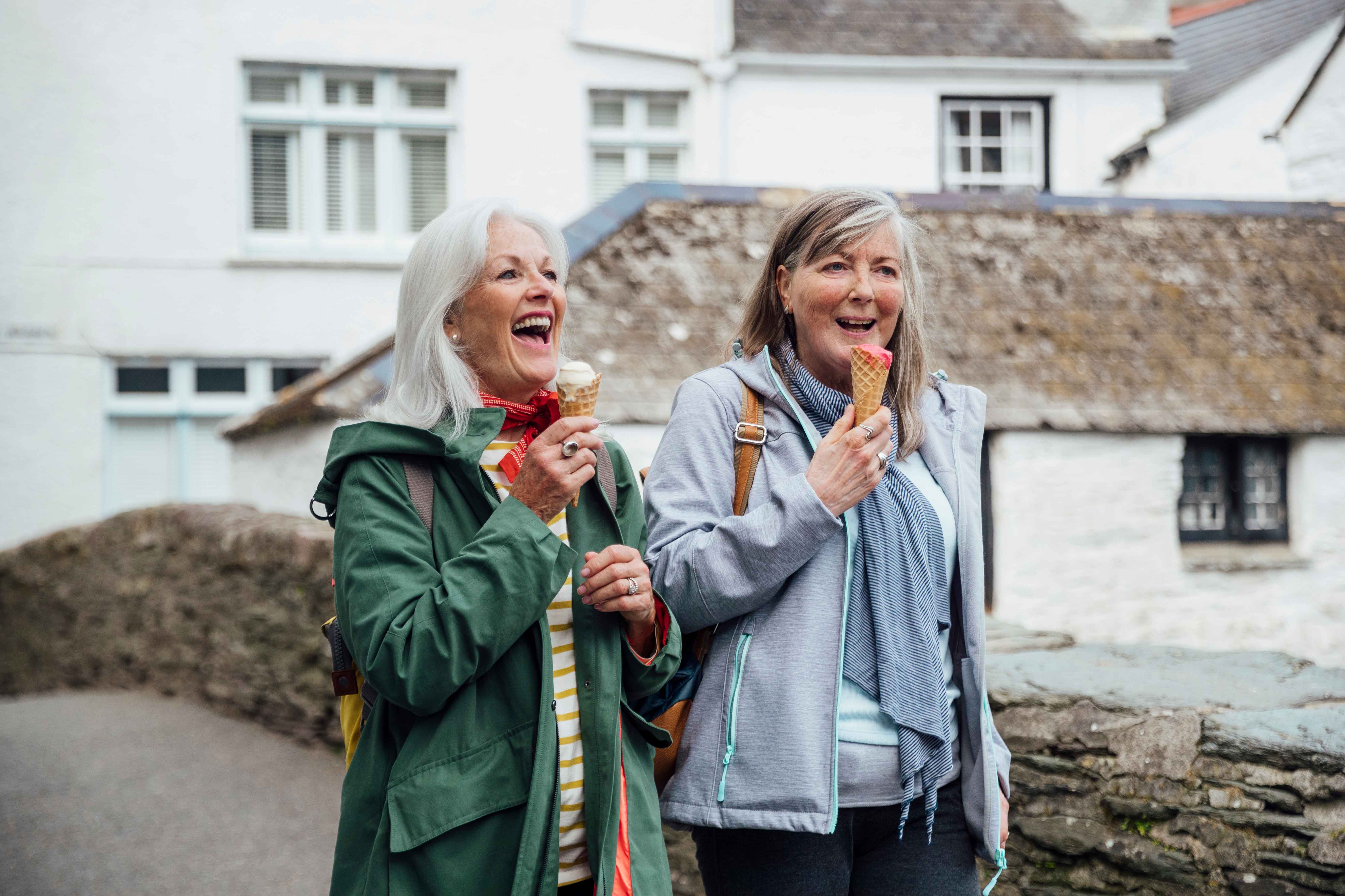 2 women laughing and eating ice cream