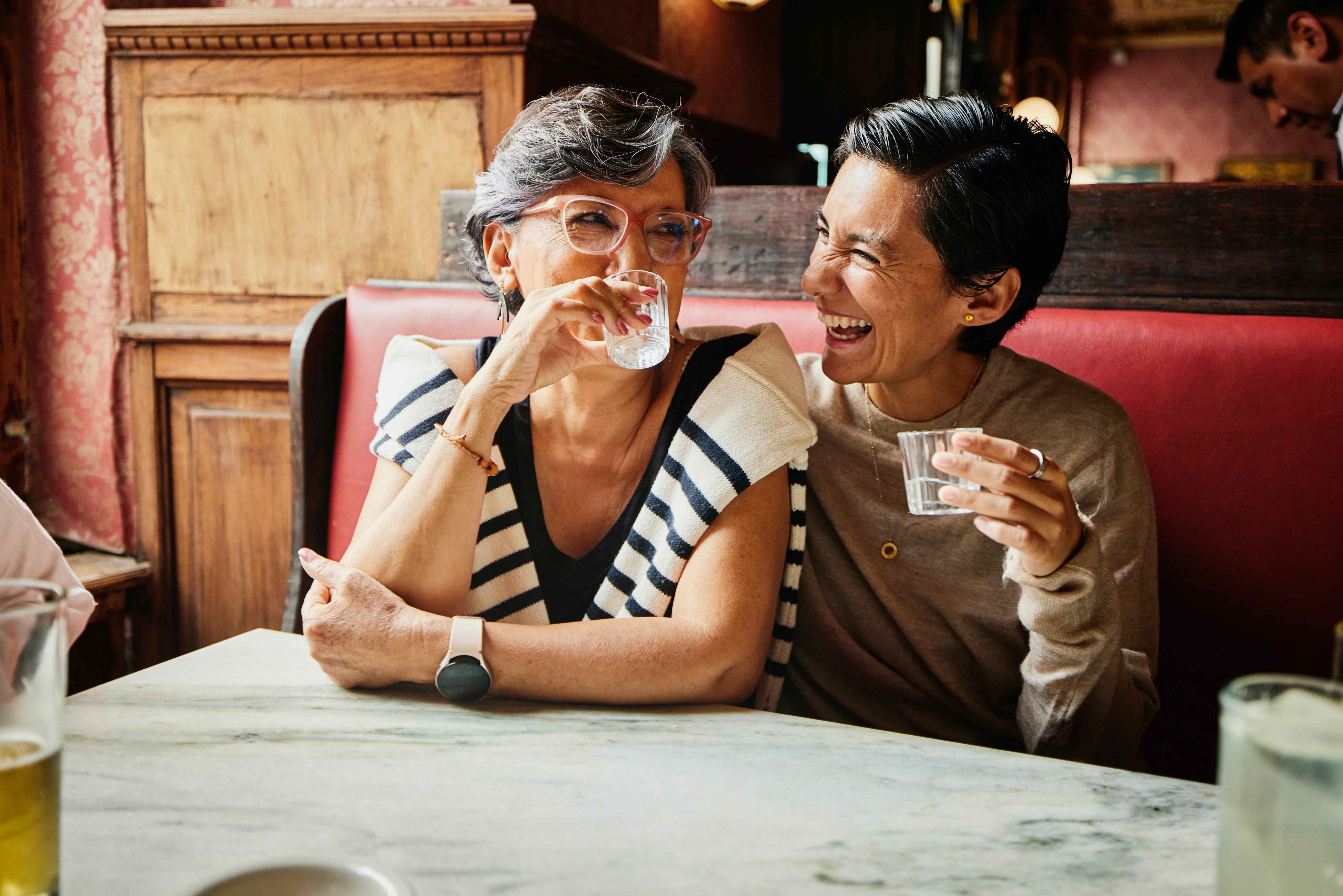 Women laughing in a cafe