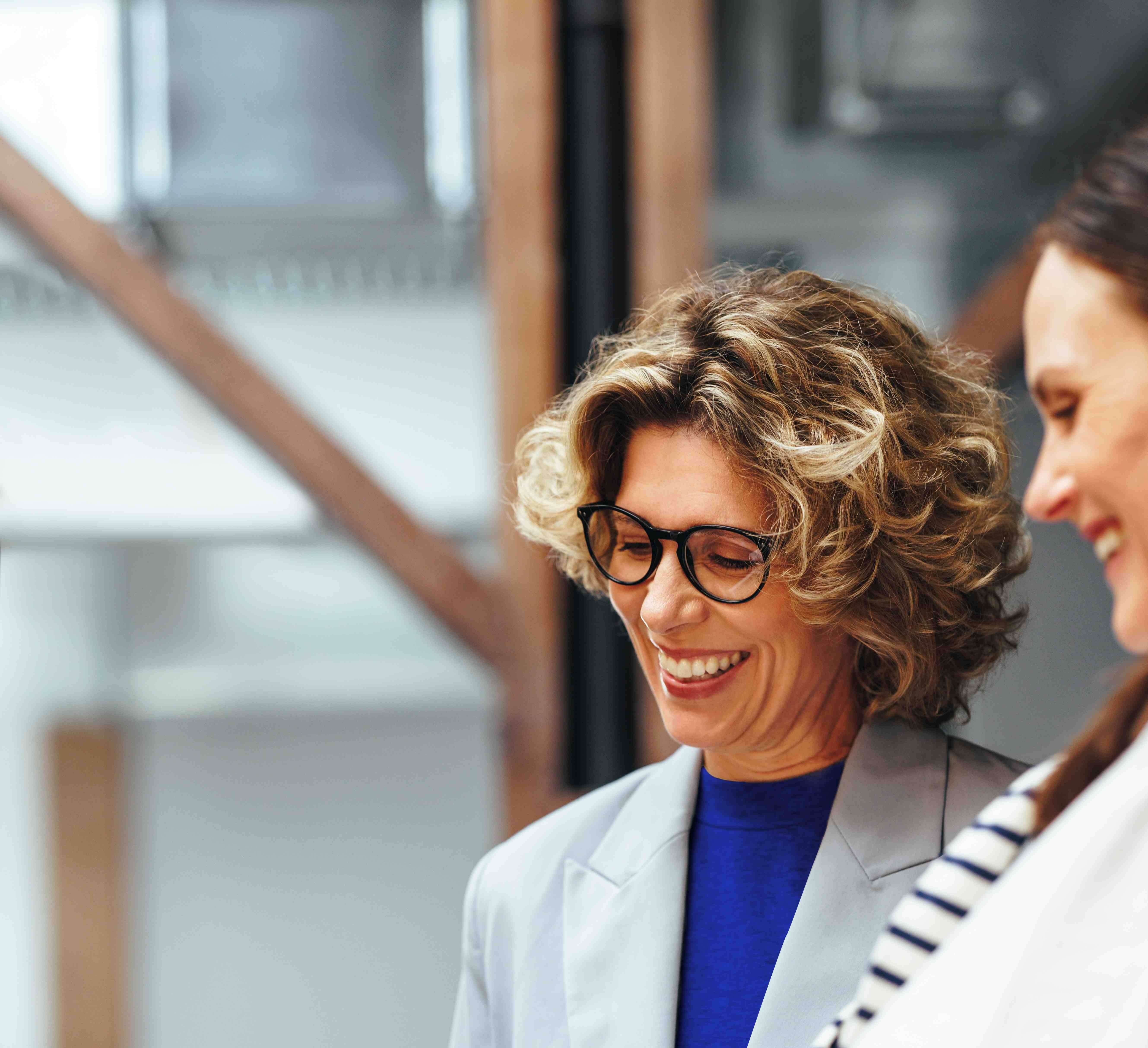 a woman working with her colleague on a tablet