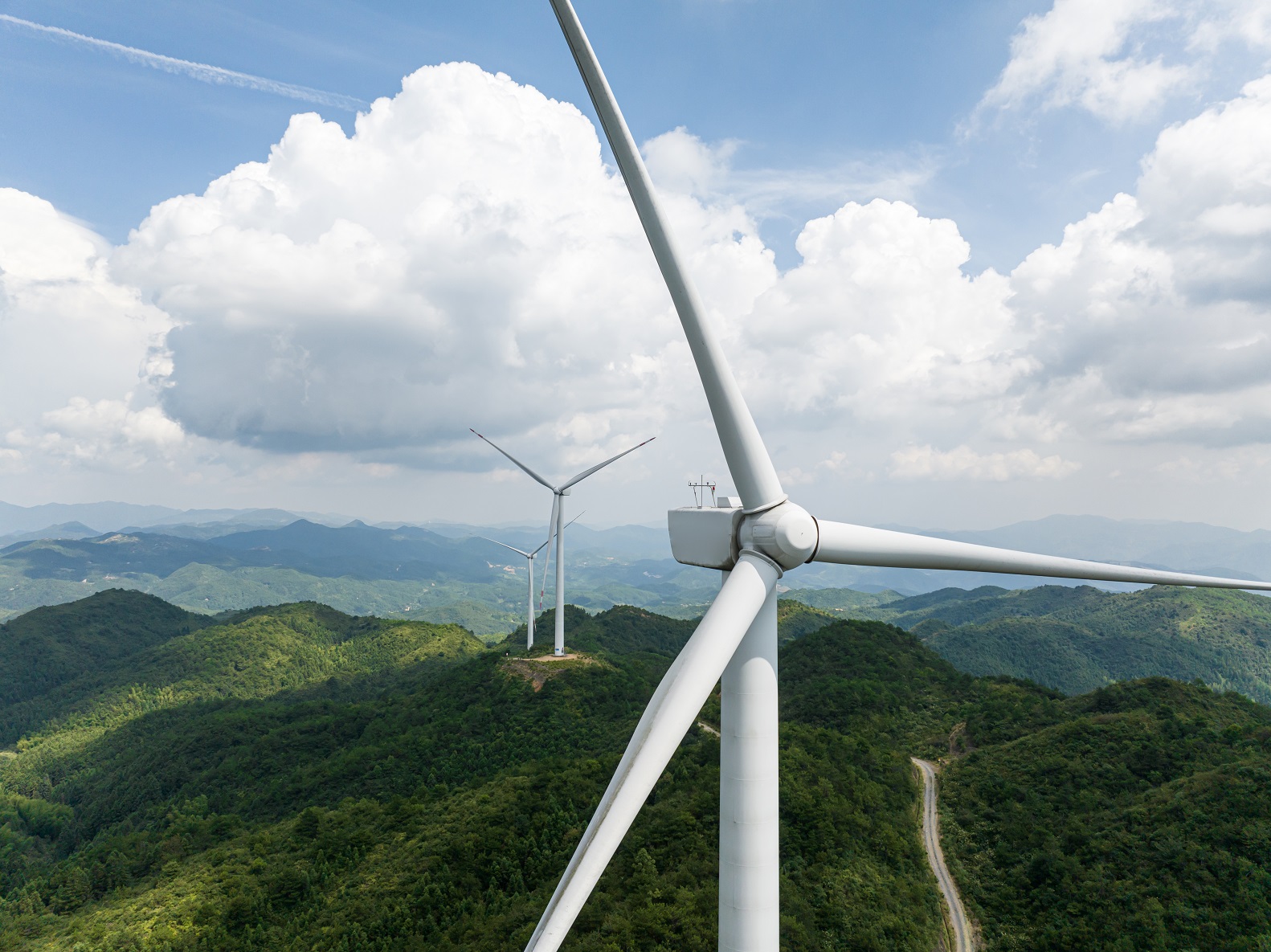 Wind turbines spinning in the wind on a hilltop