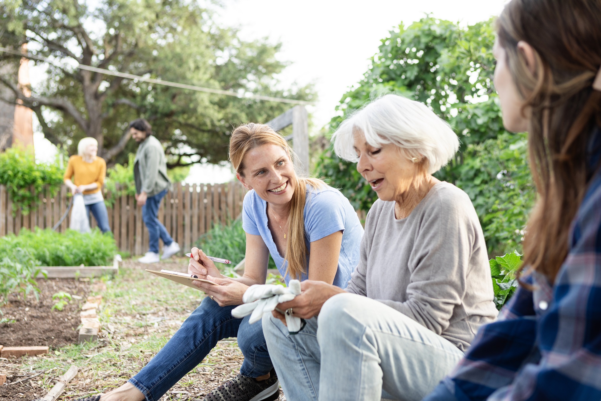 Three charity trustees sat down outside at a charity investment event