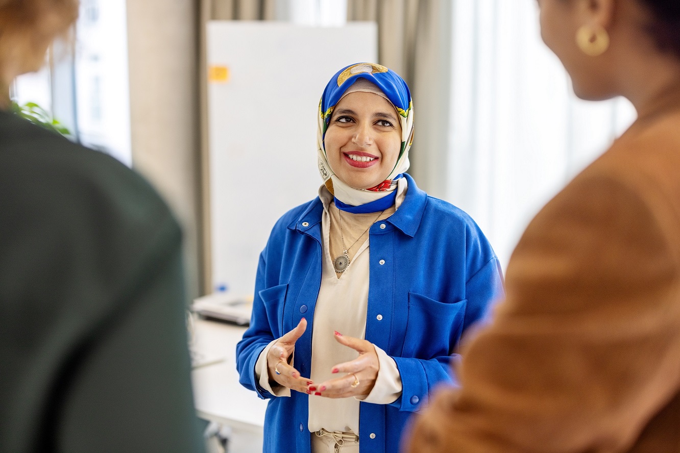 Three charity trustees talking in a group about the importance of investment governance within charities