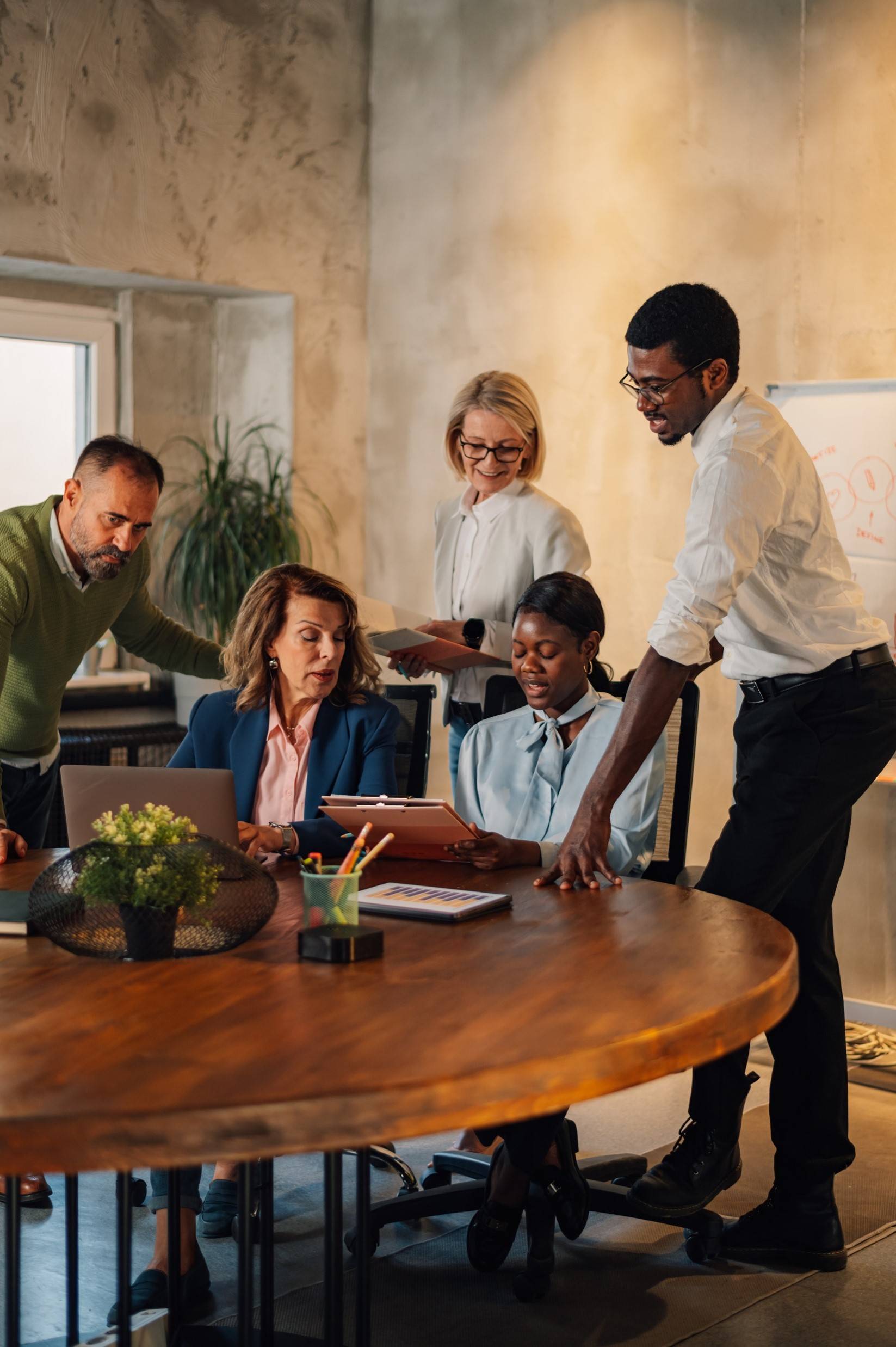 A group of financial advisers meet in a rustic conference room