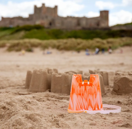 a sandcastle and bucket