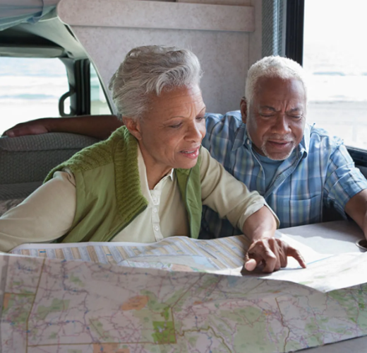 An older couple looking at a map together