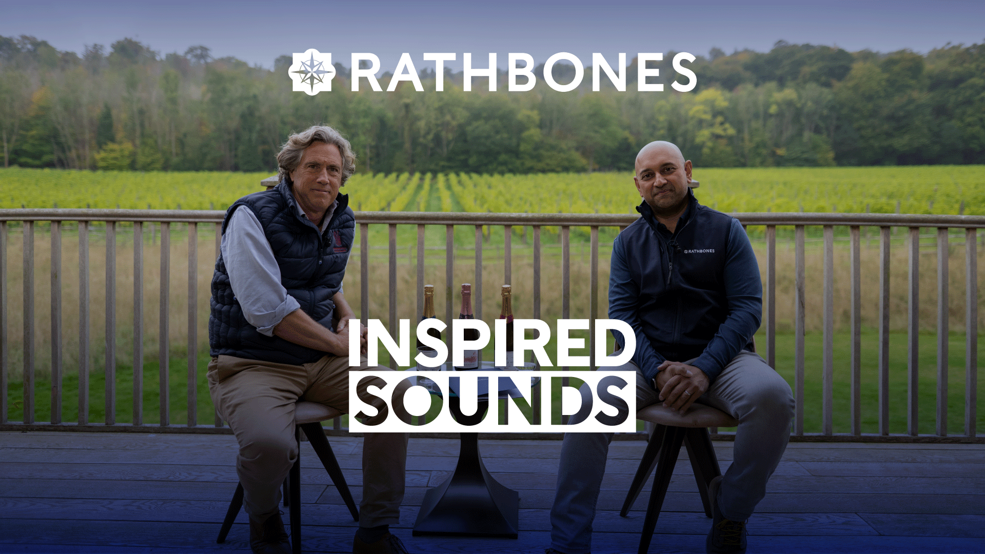 An image for the Inspired Sounds podcast showing two people looking out over a vineyard