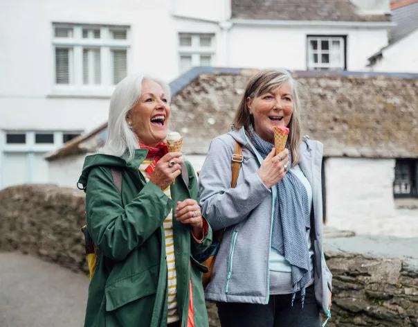 2 women laughing and eating ice cream