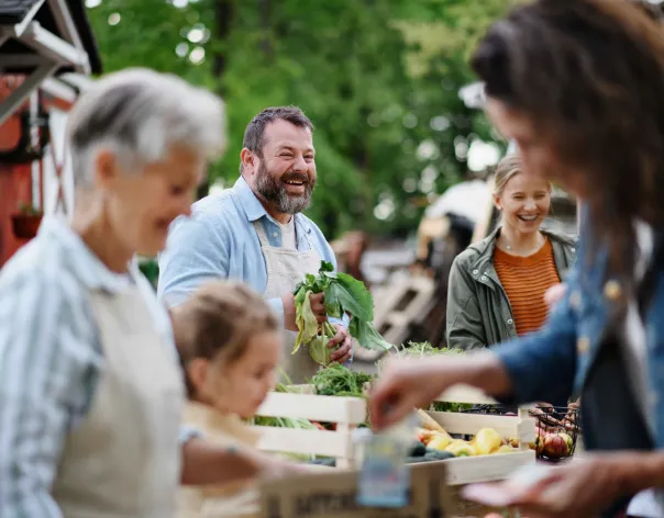 a man and his family tend to some plants