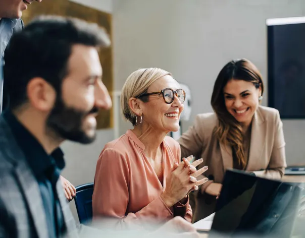 group of colleagues smiling and chatting