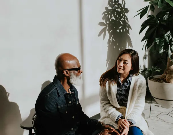 Two friends talking on a porch