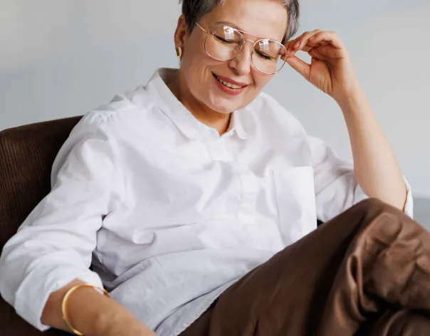 Woman sitting and laughing in an armchair