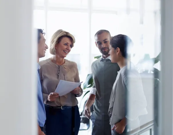 Colleagues in a company discussing a topic in the office together