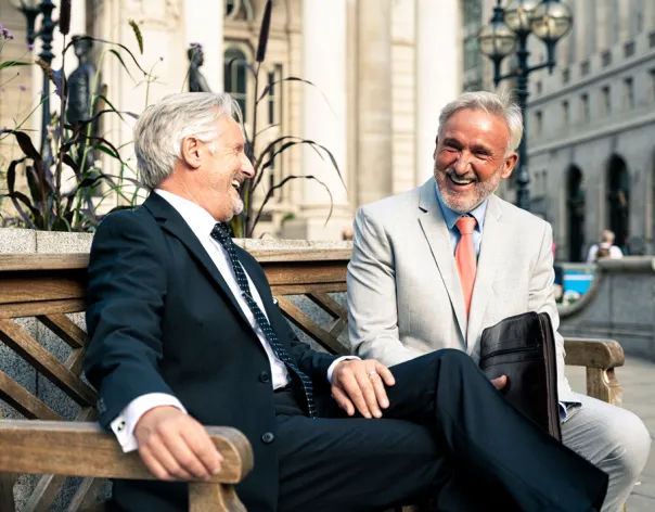 A man smiles while wearing a suit in the winter