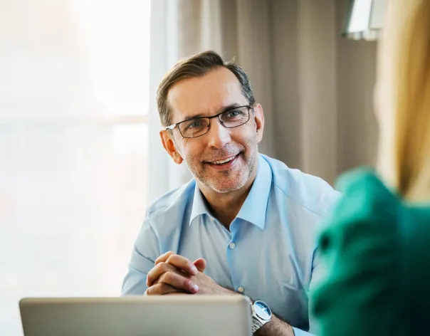 A financial adviser listens to his client in a meeting about their investment portfolioA financial adviser listens to his client in a meeting about their investment portfolio