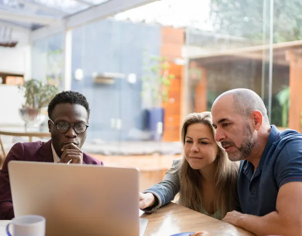 A couple meet with a Rathbones financial planner to discuss their pensions