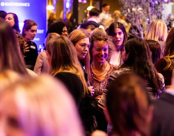 A large group of women network together at a Rathbones - Women's Chapter event in London