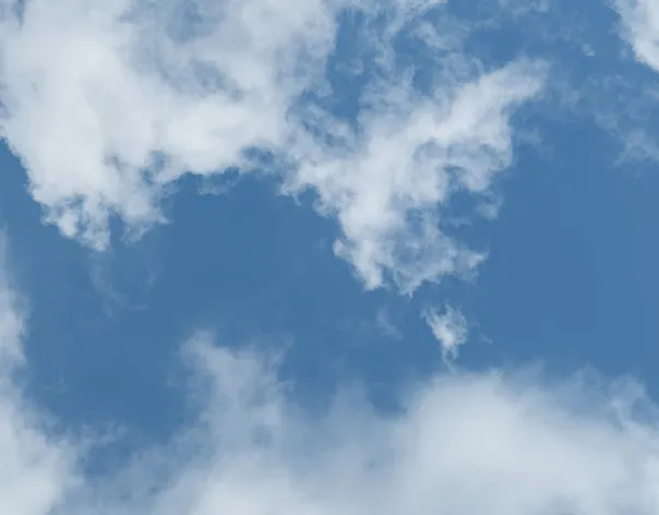 Looking skyward to a blue sky with some whispy clouds