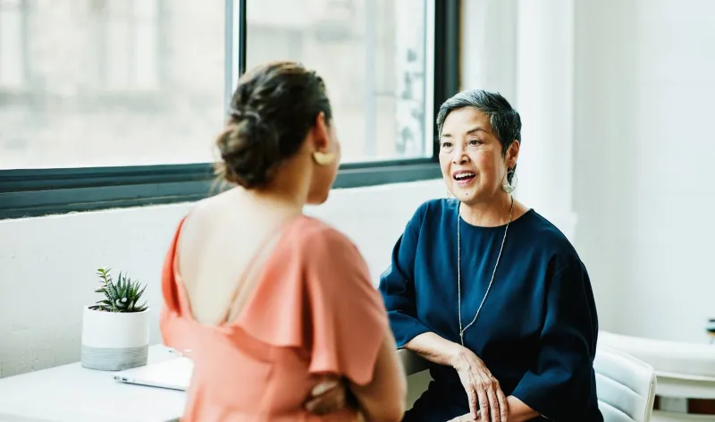 Two women meet in a cafe to talk