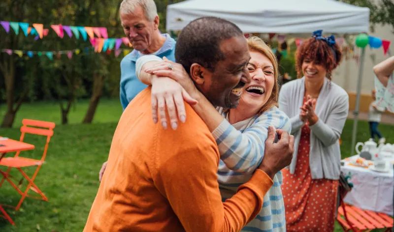 Mother and daughter flying a kite in a park