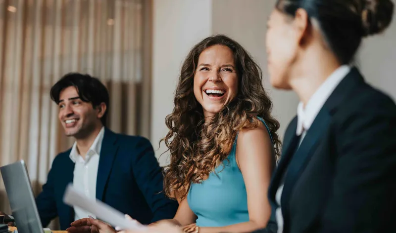 Images of people talking sat around a table