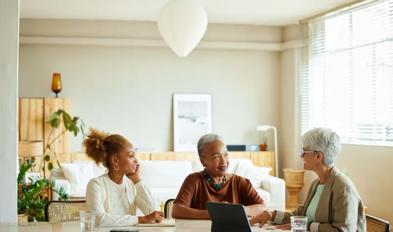 Images of people talking sat around a table