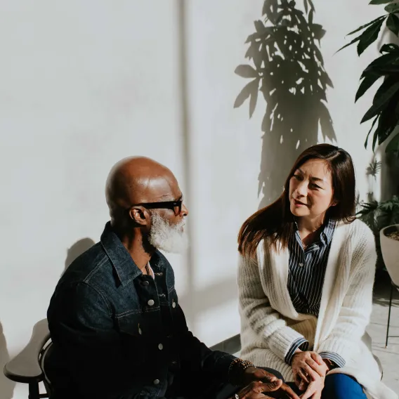 2 people talking on a porch