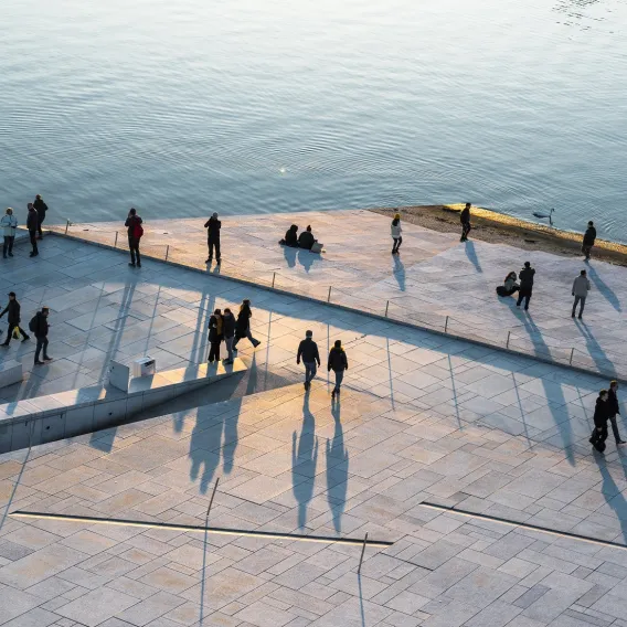People walking along a waterfront location