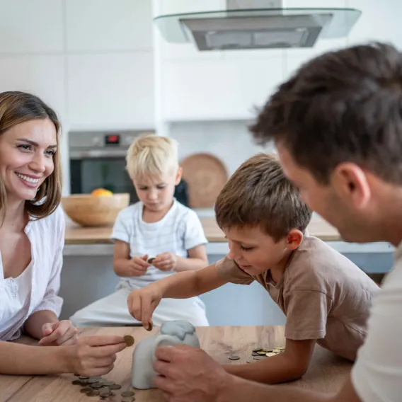 A young family cooks together in their kitchen