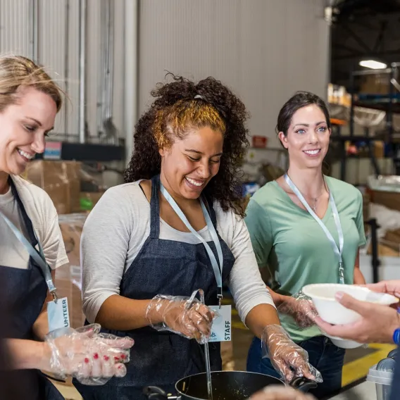 A group of people at an event discussing charity investment 