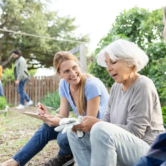 Three charity trustees sat down outside at a charity investment event