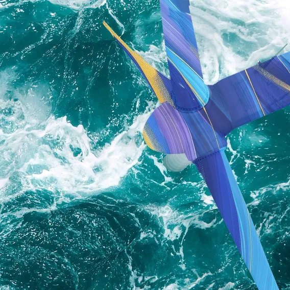 A sea turbine turns while choppy waters swirl around its base