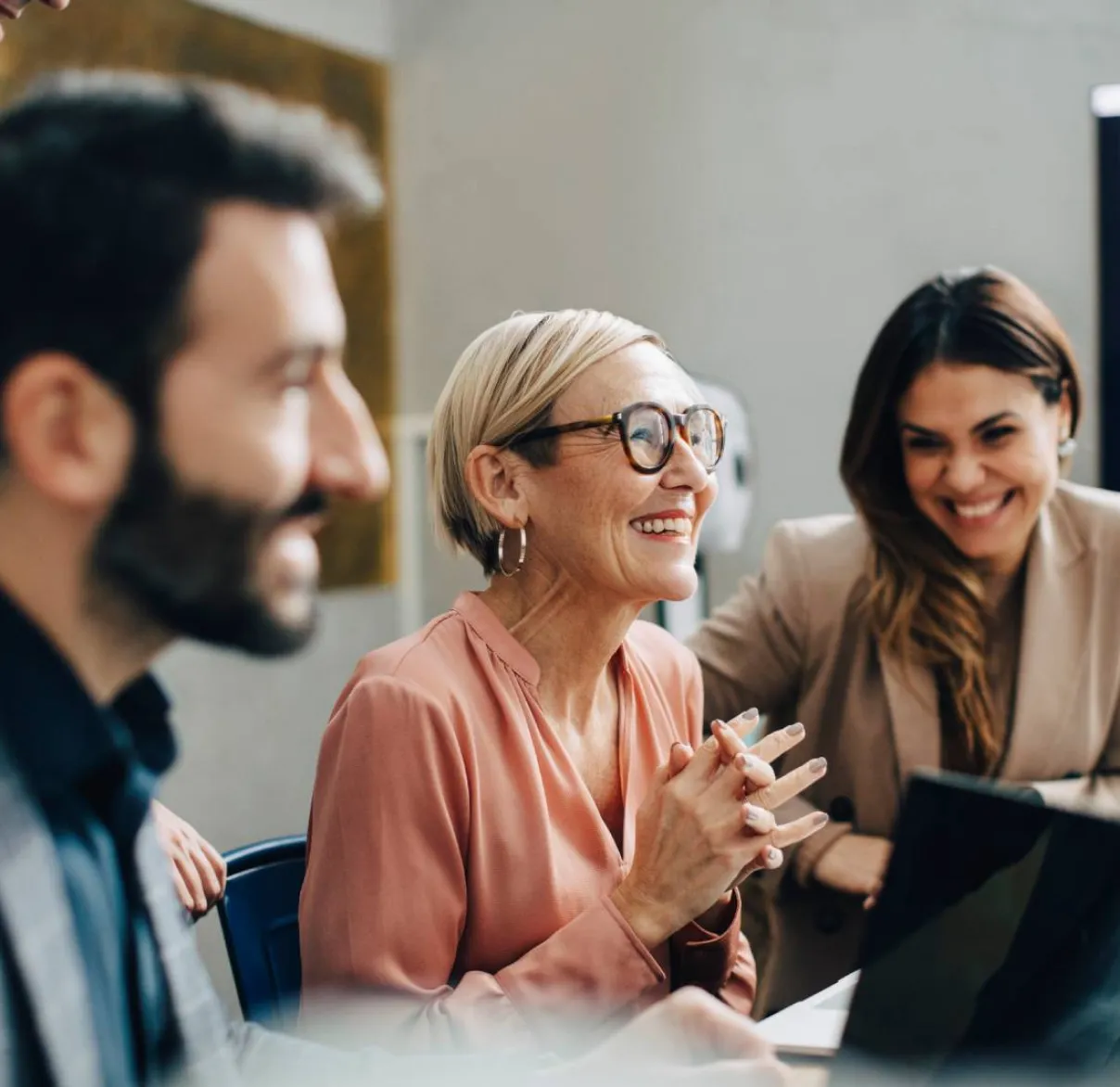 An investment management client laughs while in a meeting with their financial adviser