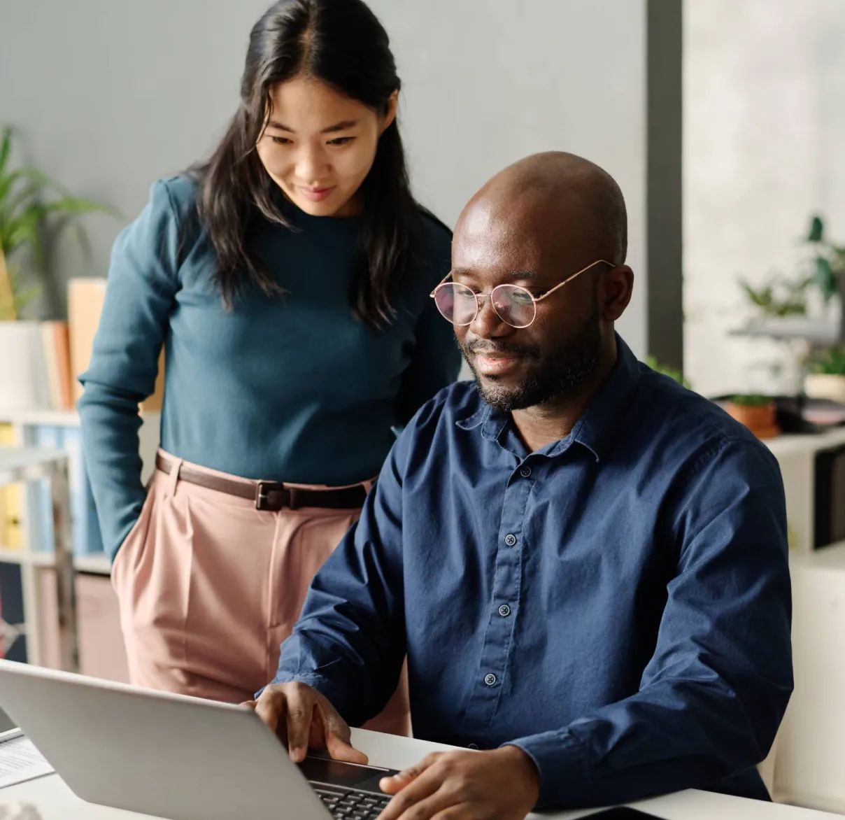 A lady working from home stops reading a piece of paper to ponder a thought