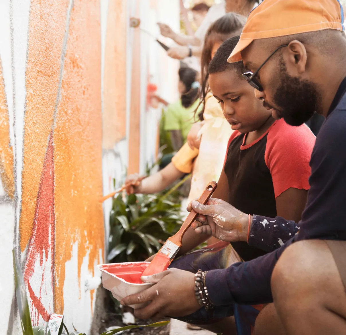 A man and child paint a wall together