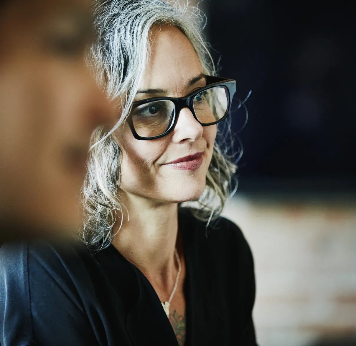 A lady wearing glasses with grey hair