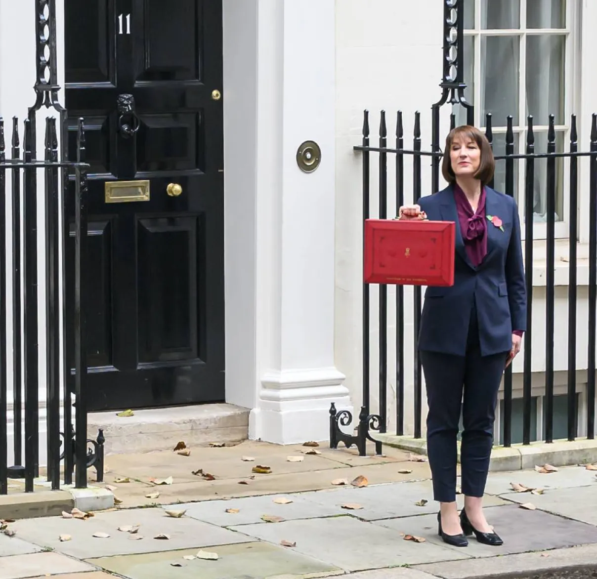 Rachel Reeves in front of building with red case