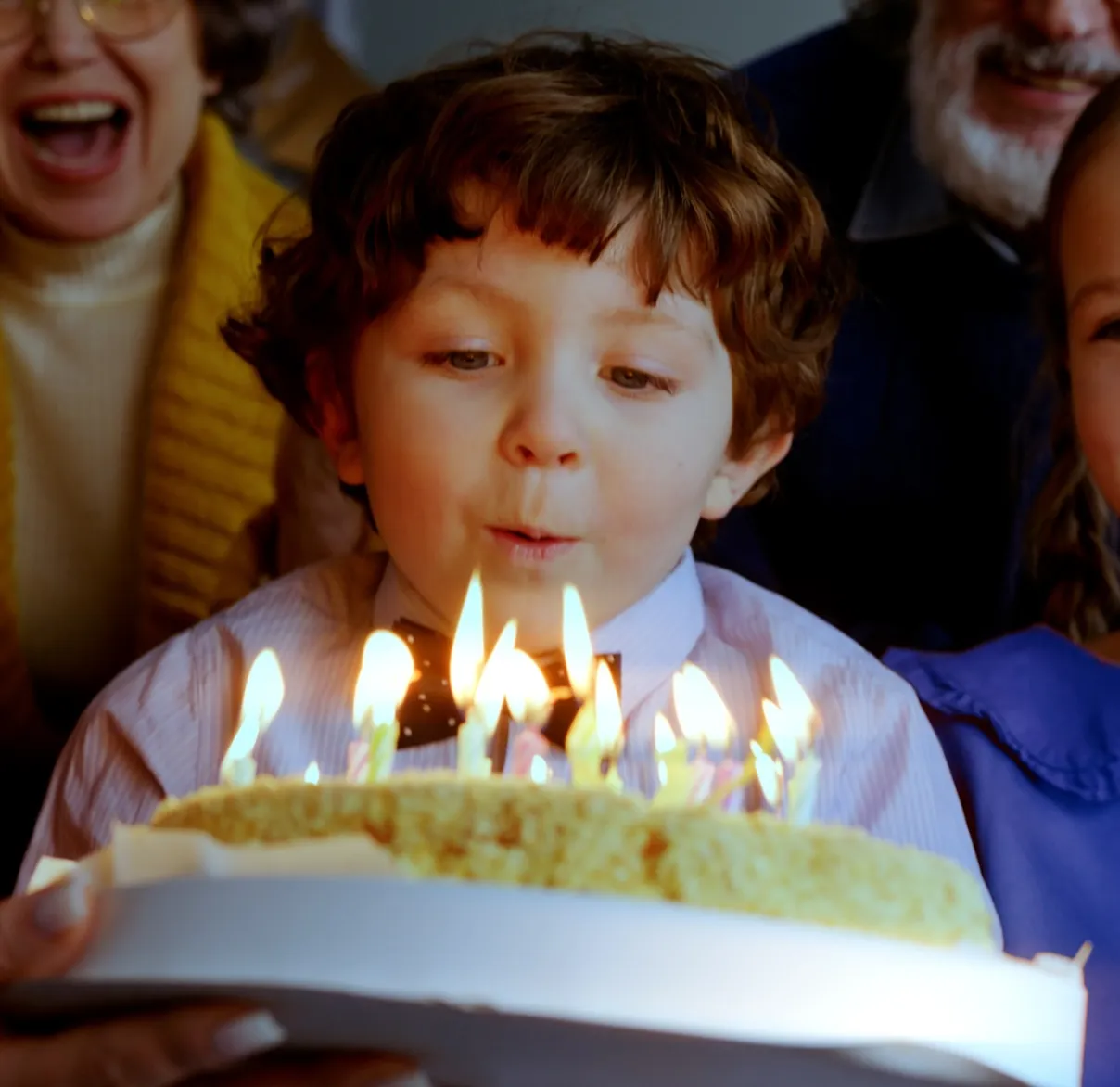 Boy blowing candles