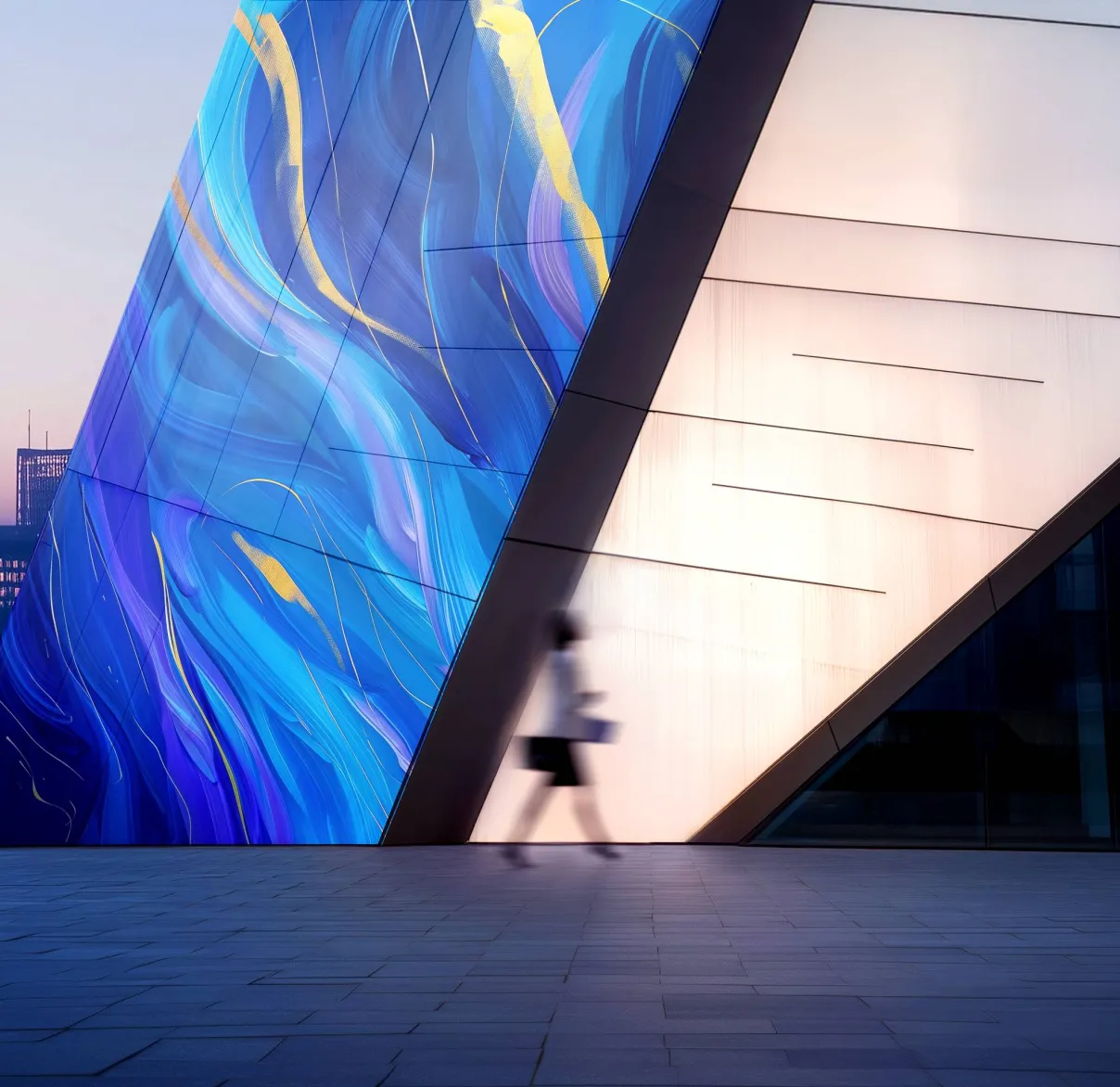 A businesswoman walks past a modern building in the city with a swirl of blues and yellows on one side of it