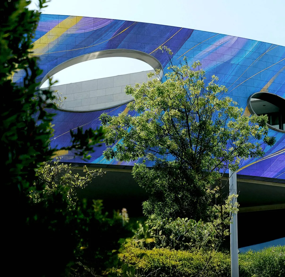The outside of a building with large holes cut out of its walls