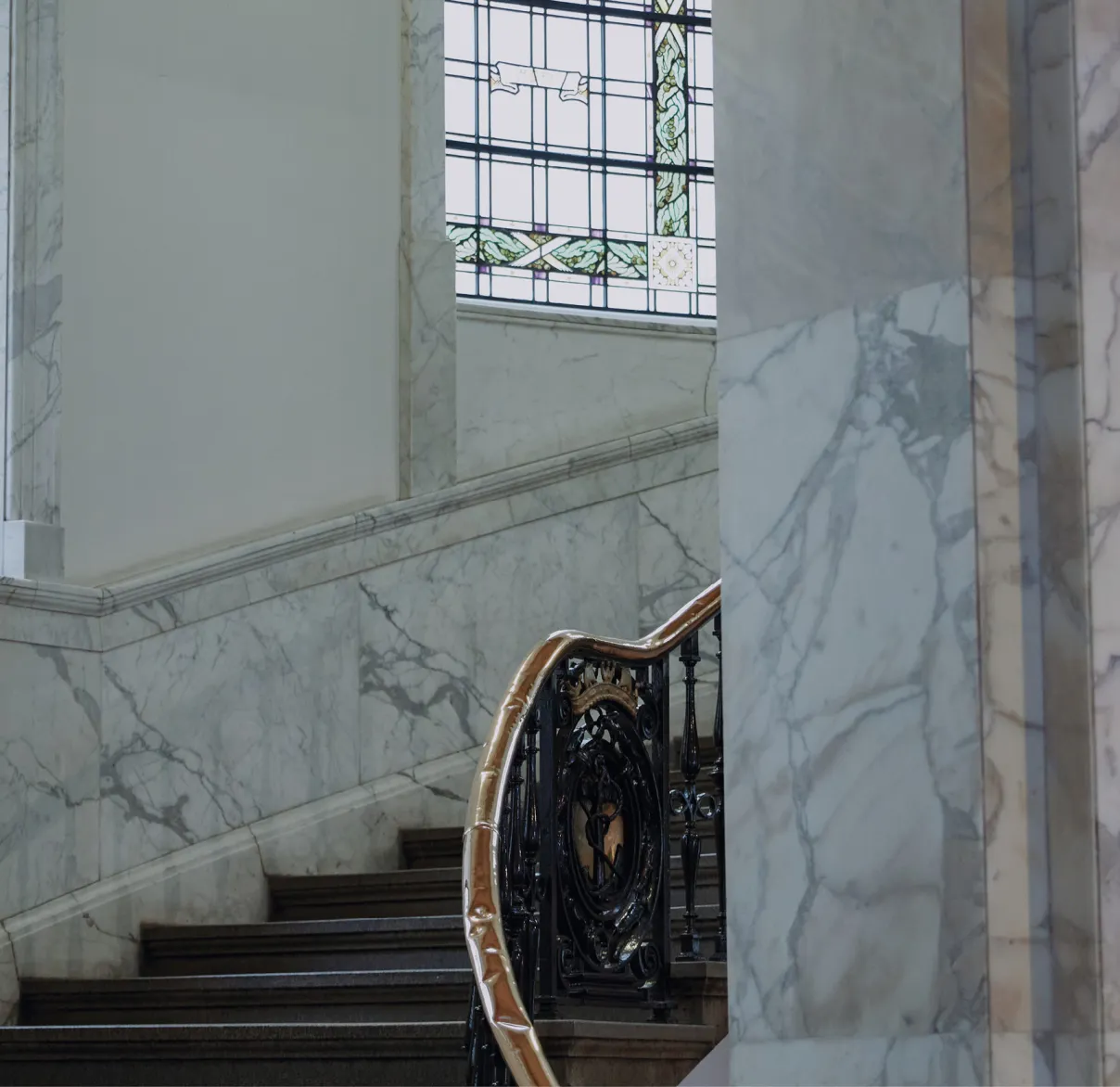 An ascending set of stairs surrounded by marble walls