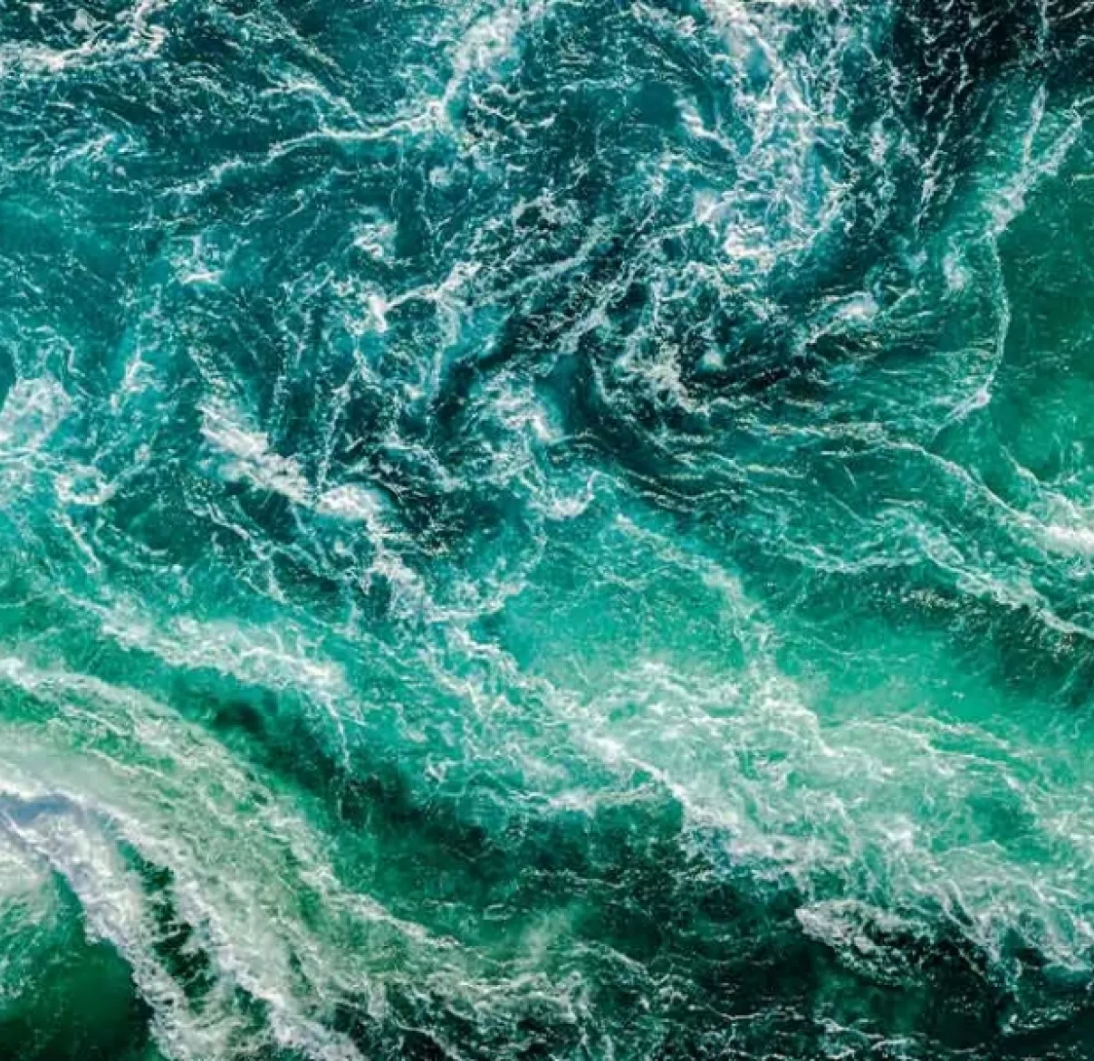 Looking down on a blue-green sea that's swirling