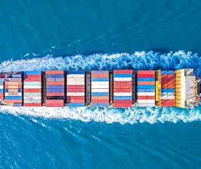 photograph of shipping container in the sea from above