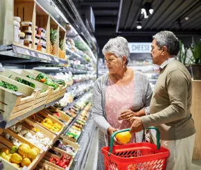 Couple in fruit aisle in supermarket