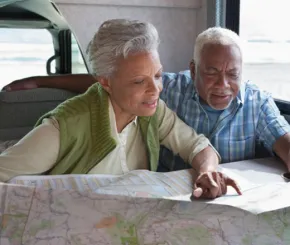 An older couple looking at a map together