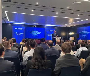 Image with people watching a conference 