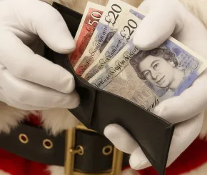 Santa opening a wallet containing £20 and £50 notes