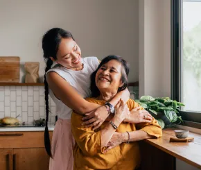 Mother and daughter hugging and smiling
