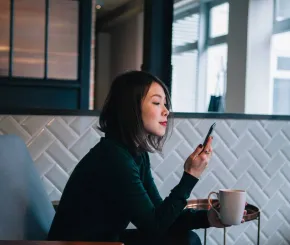 Businesswoman on phone in coffee shop
